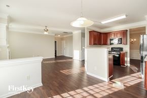 Lexington house for rent - a renovated kitchen and living room with wood flooring and white walls