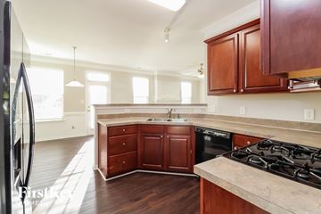 Lexington house for rent - a kitchen with wooden cabinets and a stove and a sink