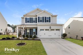 Wake Forest house for rent - A large white house with a garage is shown in the image.