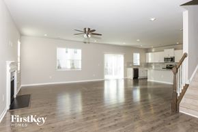 Wake Forest house for rent - A spacious living room with a staircase on the right side.