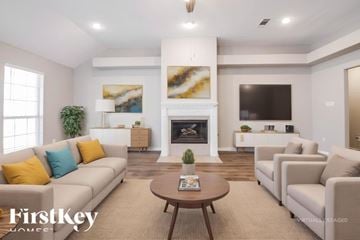 Joshua house for rent - A virtual staged living room with a fireplace and a painting on the wall.