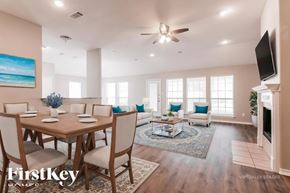 Joshua house for rent - A well-lit, spacious dining room with a wooden table and chairs.