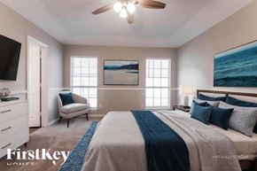 Joshua house for rent - A bedroom with a large bed and a painting of the ocean on the wall.