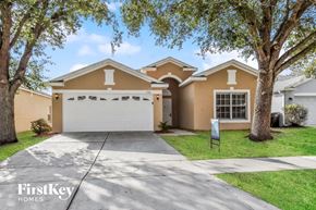Seffner house for rent - a beige house with a white garage door