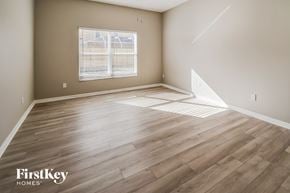Seffner house for rent - the living room with hardwood flooring and a window