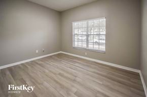 Seffner house for rent - a bedroom with wood flooring and a window