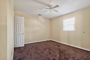 Forsyth apartment for rent - A room with a ceiling fan and a window.