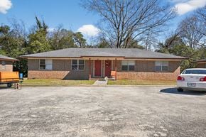 Macon apartment for rent - A house with a red door and a car parked in front.
