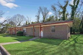 Macon apartment for rent - A red brick house with a white door and windows.