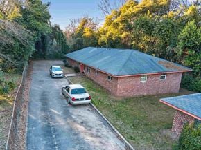 Macon apartment for rent - A house with a red roof and a car parked in front.