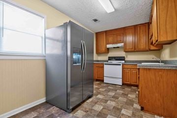 Forsyth apartment for rent - A kitchen with a refrigerator, stove, and sink.