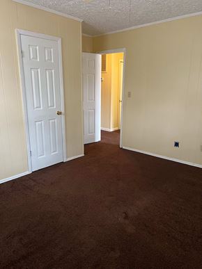Forsyth apartment for rent - A room with a carpeted floor and two doors.