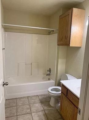 Tulsa apartment for rent - A white bathroom with a toilet, sink, and shower.