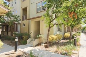 San Jose house for rent - the front of an apartment building with stairs and a tree