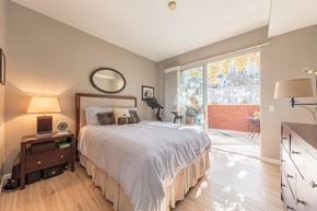 San Jose house for rent - a bedroom with a bed and a sliding glass door to a patio