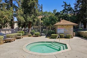 San Jose house for rent - A small pool surrounded by a concrete patio and a small building with a sign that says "TRE".