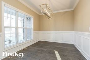 Clarksville house for rent - A well-lit room with a large window and a chandelier.