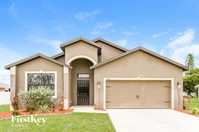 Cape Coral house for rent - A house with a garage and a driveway in front of it.