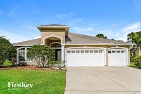 Fleming Island house for rent - A house with a white garage door is for sale.