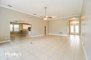 Fleming Island house for rent - A spacious room with a ceiling fan and tile flooring.
