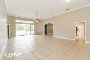 Fleming Island house for rent - A spacious room with a sliding glass door and a ceiling fan.