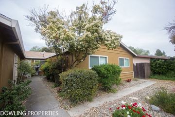 Davis apartment for rent - A yellow house with a tree in bloom in front of it.