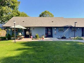 Junction City apartment for rent - A house with a blue exterior and a green lawn.