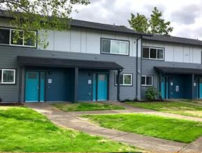 Eugene apartment for rent - a building with blue doors and a green lawn