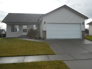 Coeur D' Alene house for rent - a white house with a driveway and a white garage door