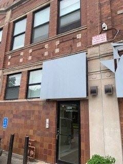 Chicago apartment for rent - the front of a brick building with a glass door