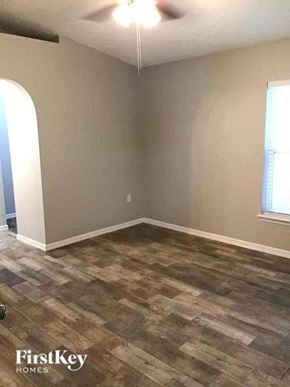 Jacksonville house for rent - A room with a wooden floor and a window.