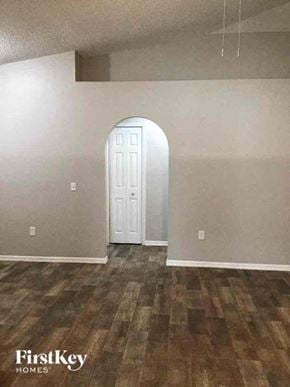 Jacksonville house for rent - A room with a white door and wooden flooring.