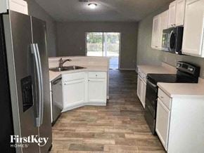 Jacksonville house for rent - A kitchen with a refrigerator, sink, and cabinets.