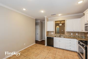 Fort Worth house for rent - A kitchen with a stove top oven and a counter top.