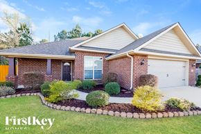 Montevallo house for rent - A brick house with a well-maintained garden in front.