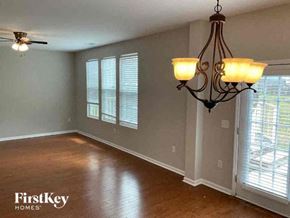 Goose Creek house for rent - an empty living room with a chandelier and a window