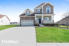 Clarksville house for rent - A two-story house with a garage is showcased in the image.