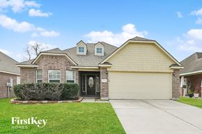 Conroe house for rent - the front of a house with a driveway and grass