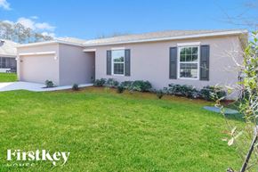 Port St. Lucie house for rent - A house with a well-maintained lawn and a clear blue sky.