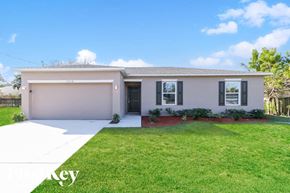 Port St. Lucie house for rent - A house with a garage and a driveway in front of it.