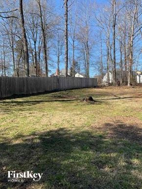 Charlotte house for rent - a backyard with a fence and some trees