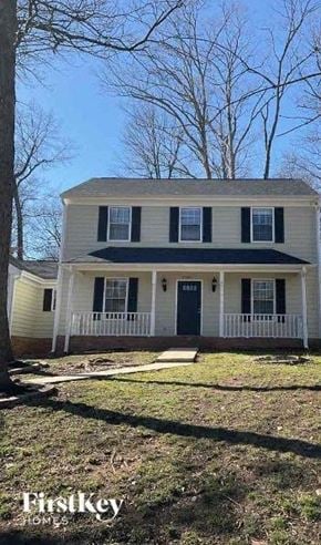 Charlotte house for rent - a white house with a blue roof and a yard