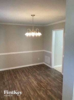 Charlotte house for rent - a empty dining room with a chandelier and wood floors