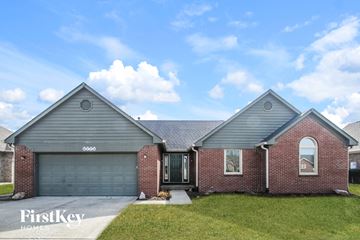 Plainfield house for rent - front exterior view of a brick home with gray siding and a gray garage door