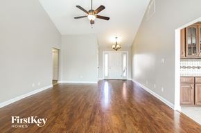 Plainfield house for rent - an empty living room with wood floors and a ceiling fan