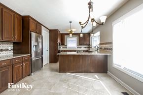 Plainfield house for rent - a kitchen with wooden cabinets and stainless steel appliances