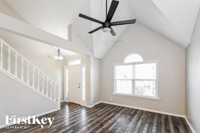 Avon house for rent - A spacious room with a wooden floor and a ceiling fan.