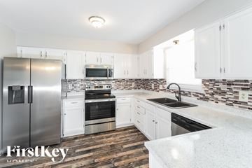 Avon house for rent - A kitchen with a refrigerator, oven, sink, and cabinets.