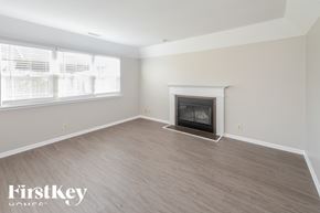 Avon house for rent - A spacious living room with a fireplace and wooden flooring.