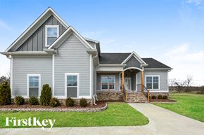 Bessemer house for rent - A house with a grey exterior and a white door is shown.